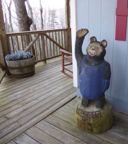 Carved welcome bear on the porch of the CradleCrest cabin